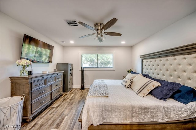 618 SE 26th St, Cape Coral, FL 33904 - bedroom with freestanding refrigerator, light wood-style flooring, baseboards, recessed lighting, and ceiling fan
