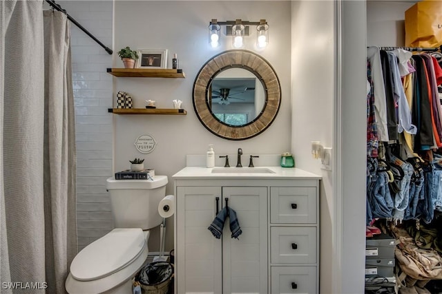 618 SE 26th St, Cape Coral, FL 33904 - bathroom with toilet, vanity, a shower with shower curtain, and a spacious closet