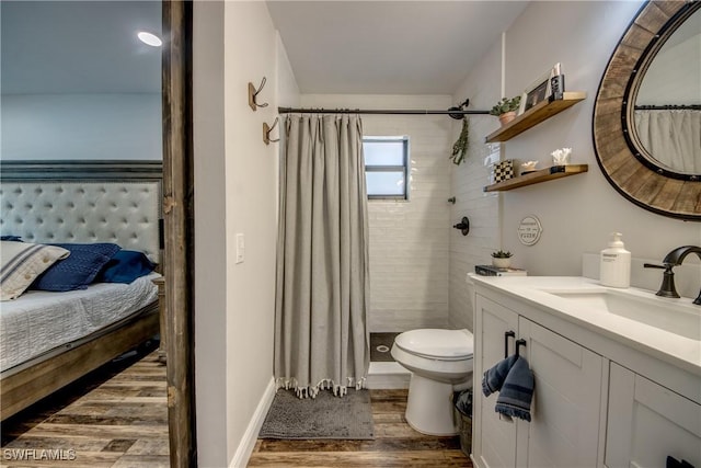 618 SE 26th St, Cape Coral, FL 33904 - full bath featuring wood finished floors, toilet, tiled shower, and vanity