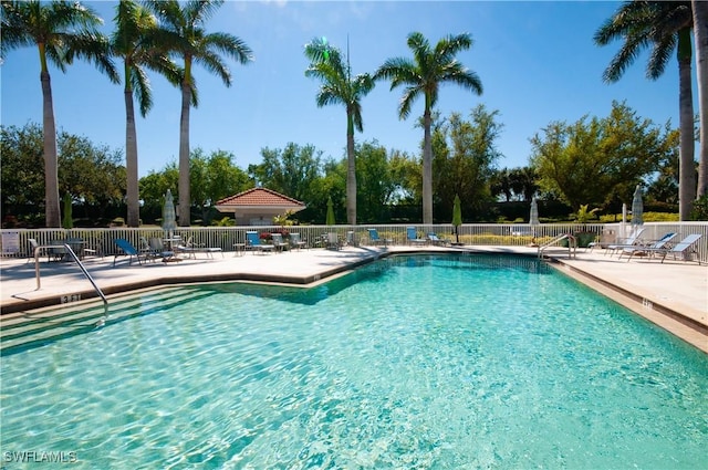 community pool featuring a patio area and fence