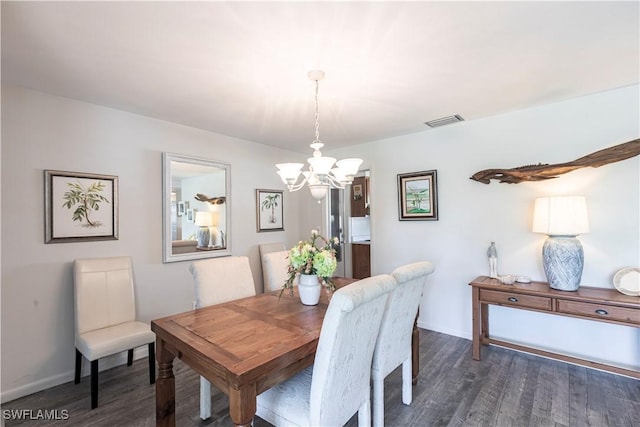 dining space featuring a chandelier, visible vents, baseboards, and dark wood-style floors