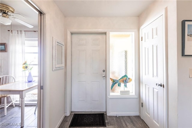 entrance foyer with dark wood-style floors, baseboards, and ceiling fan