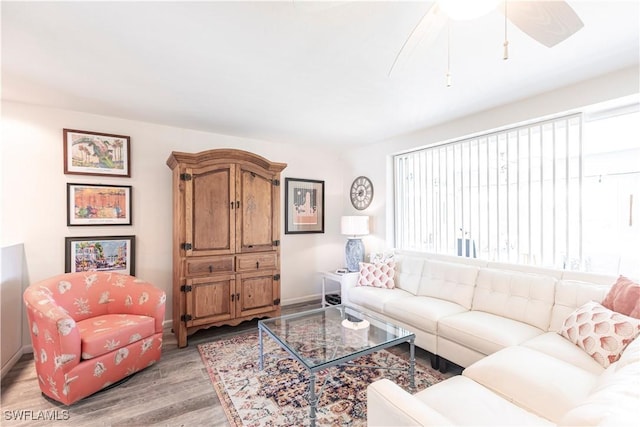 living area with light wood-type flooring and ceiling fan