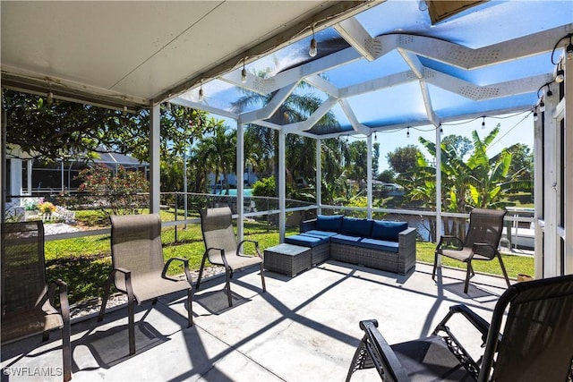 view of patio with an outdoor living space and glass enclosure