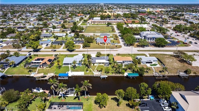 drone / aerial view featuring a residential view and a water view