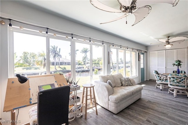 living room with a ceiling fan and wood finished floors