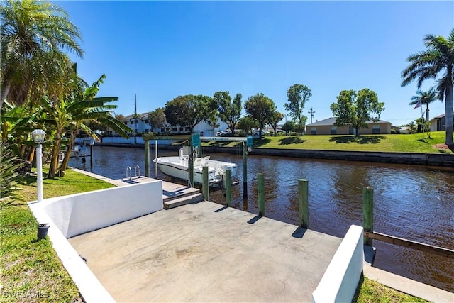 view of dock featuring a yard, a water view, and boat lift