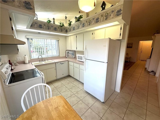 kitchen featuring range hood, light countertops, light tile patterned flooring, a sink, and white appliances