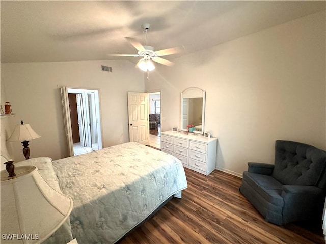 bedroom featuring dark wood-type flooring, visible vents, vaulted ceiling, and a ceiling fan