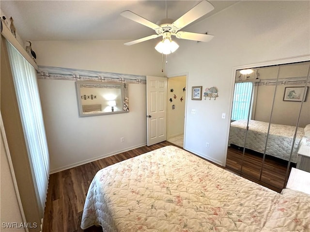 bedroom featuring baseboards, ceiling fan, wood finished floors, vaulted ceiling, and a closet