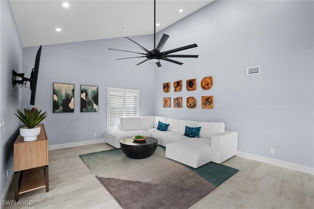 living room with visible vents, baseboards, recessed lighting, light wood-style flooring, and a ceiling fan