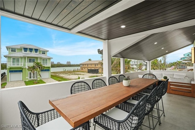 view of patio with outdoor dining area and a water view