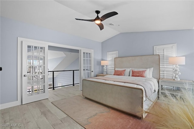 bedroom with a ceiling fan, wood finished floors, visible vents, vaulted ceiling, and french doors