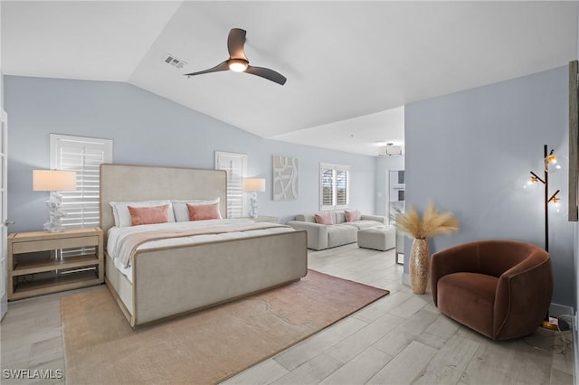 bedroom featuring vaulted ceiling, wood finished floors, a ceiling fan, and visible vents