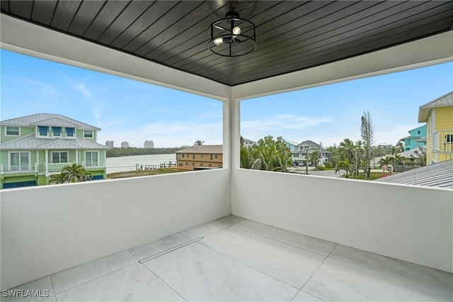 balcony featuring a ceiling fan and a water view