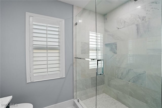 full bath featuring plenty of natural light, toilet, and a shower stall