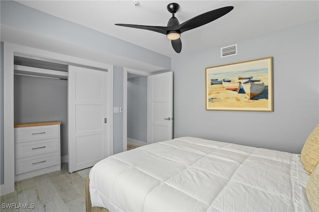 bedroom with a closet, visible vents, light wood-type flooring, and a ceiling fan