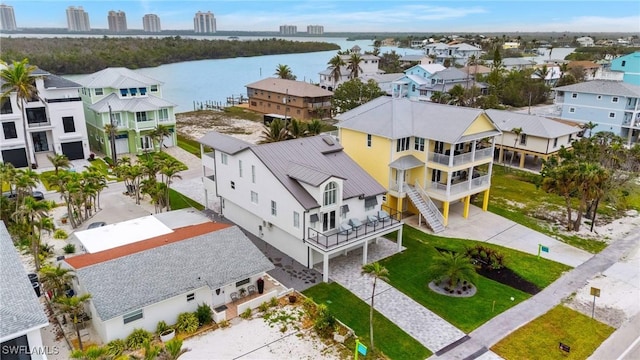 drone / aerial view with a residential view and a water view