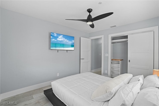 bedroom with visible vents, baseboards, ceiling fan, light wood-style floors, and a closet