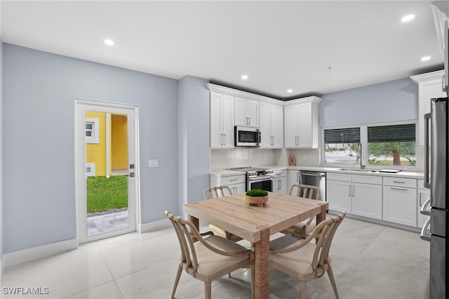 kitchen featuring recessed lighting, appliances with stainless steel finishes, white cabinetry, and light countertops