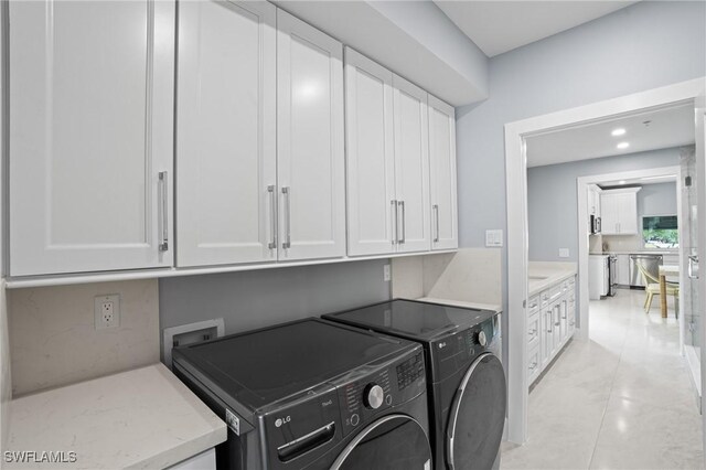 clothes washing area with recessed lighting, cabinet space, separate washer and dryer, and light tile patterned floors