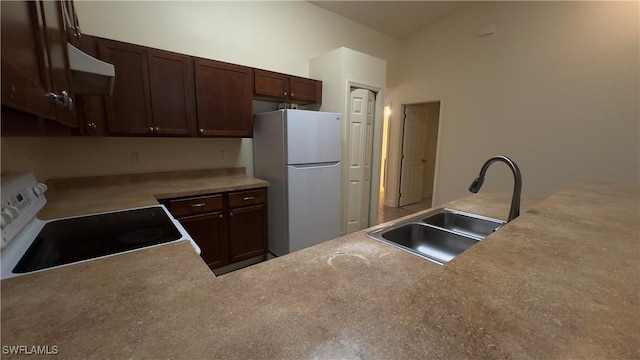 kitchen featuring white appliances, a sink, dark brown cabinets, light countertops, and range hood