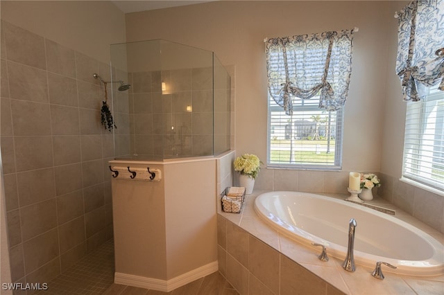 bathroom featuring a garden tub and a walk in shower