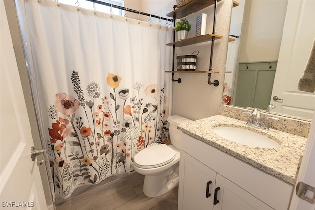 full bathroom featuring a shower with shower curtain, toilet, wood finished floors, and vanity