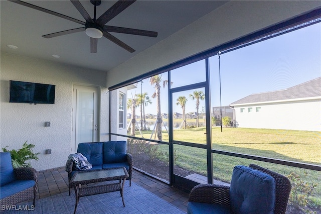 sunroom featuring a wealth of natural light and ceiling fan