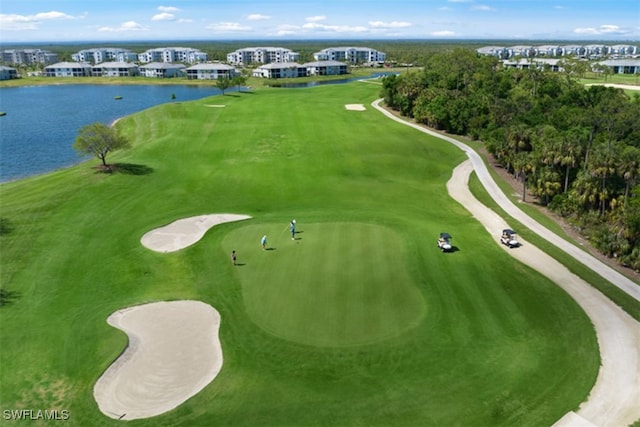 birds eye view of property featuring view of golf course and a water view