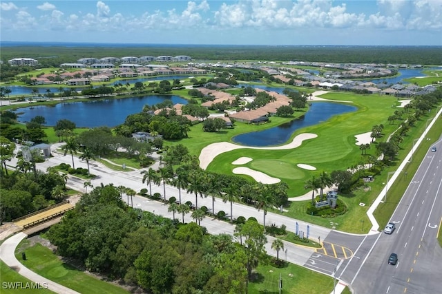 bird's eye view featuring golf course view and a water view