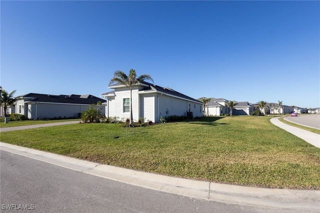 view of property exterior with a yard and a residential view