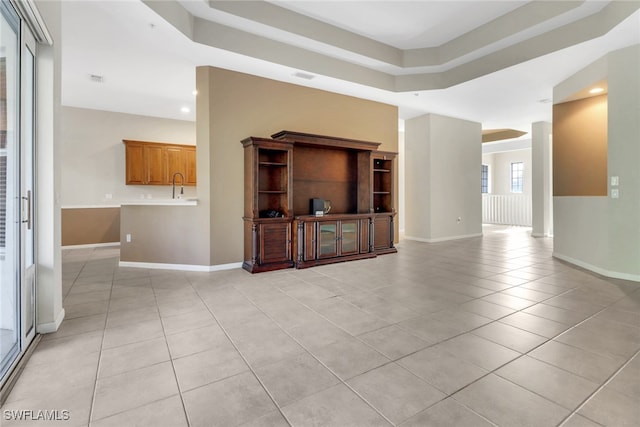 17498 Old Harmony Dr Unit 202, Fort Myers, FL 33908 - unfurnished living room with a sink, baseboards, and light tile patterned flooring