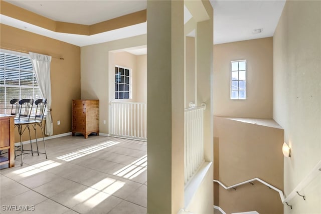 interior space featuring visible vents, baseboards, and light tile patterned flooring