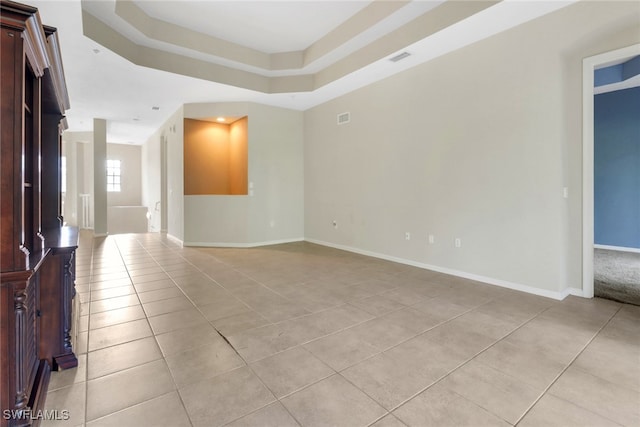 17498 Old Harmony Dr Unit 202, Fort Myers, FL 33908 - empty room with light tile patterned floors, visible vents, a tray ceiling, and baseboards