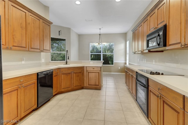 17498 Old Harmony Dr Unit 202, Fort Myers, FL 33908 - kitchen with light tile patterned floors, a peninsula, brown cabinetry, black appliances, and a sink
