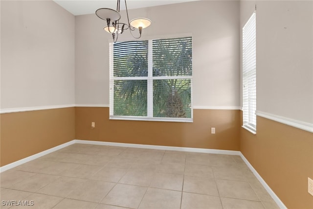 17498 Old Harmony Dr Unit 202, Fort Myers, FL 33908 - unfurnished dining area with light tile patterned floors, baseboards, and a chandelier