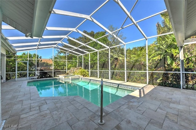 view of swimming pool with glass enclosure, a patio, and a pool with connected hot tub