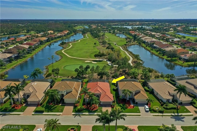 aerial view featuring golf course view, a residential view, and a water view