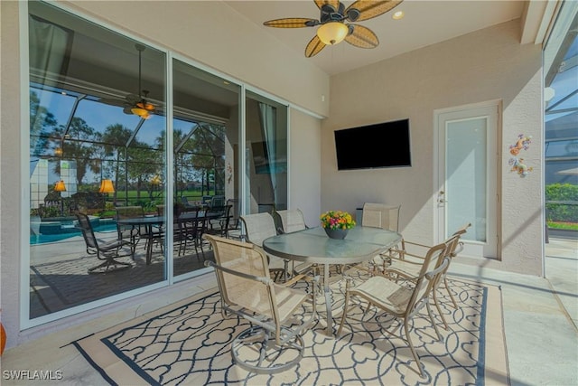 view of patio / terrace featuring ceiling fan, outdoor dining area, an outdoor pool, and a lanai