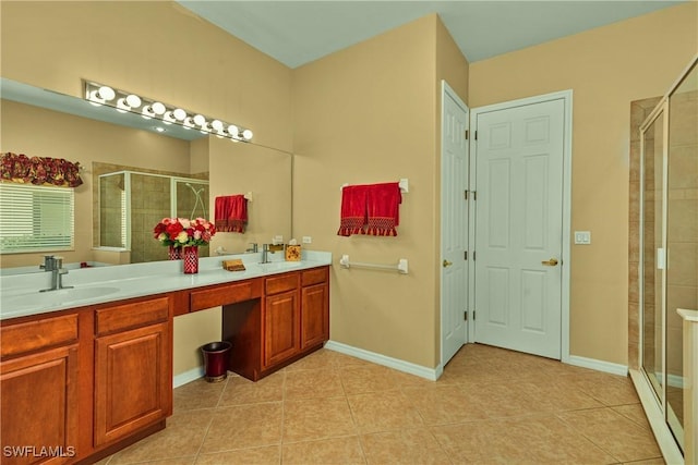 bathroom with double vanity, a shower stall, tile patterned floors, and a sink