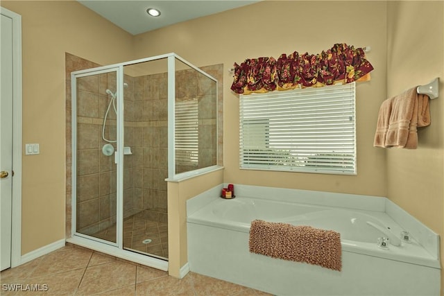 bathroom with tile patterned floors, a stall shower, and a bath