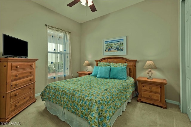 bedroom with a ceiling fan, carpet, and baseboards