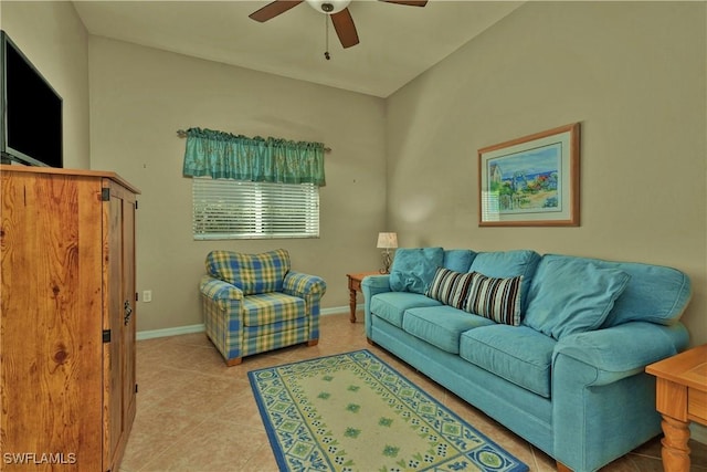 tiled living area with a ceiling fan and baseboards