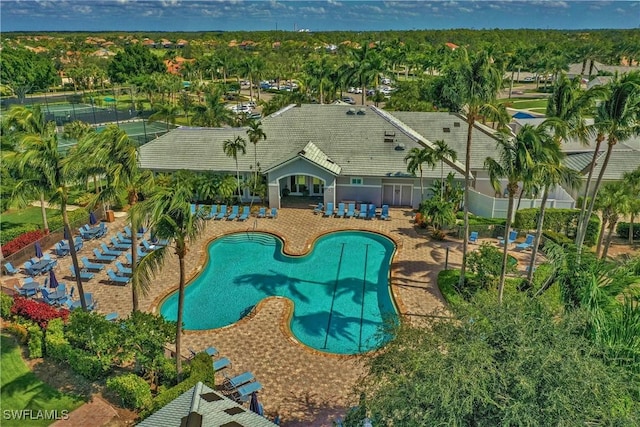 exterior space with a patio, a community pool, and fence