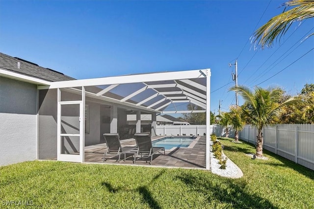 exterior space with a patio area, a yard, a lanai, and a fenced backyard