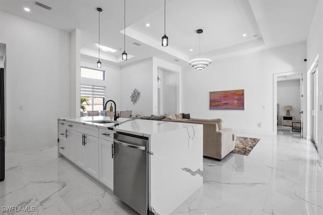 kitchen with open floor plan, marble finish floor, dishwasher, and a raised ceiling