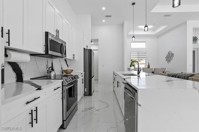 kitchen featuring visible vents, light stone counters, appliances with stainless steel finishes, marble finish floor, and a sink