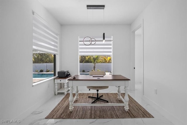 home office with baseboards and marble finish floor