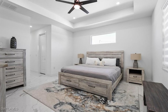 bedroom featuring recessed lighting, visible vents, marble finish floor, and a tray ceiling